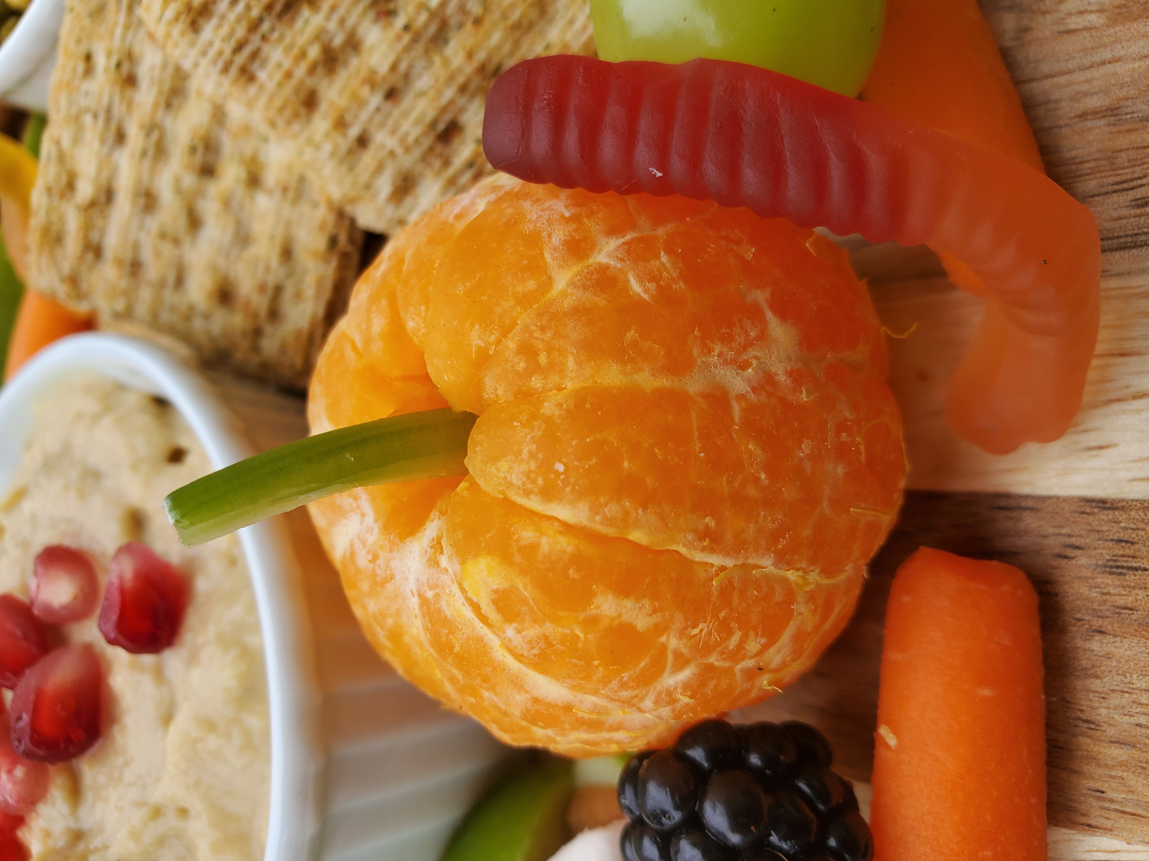 mandarin orange with a celery stick to look like a pumpkin