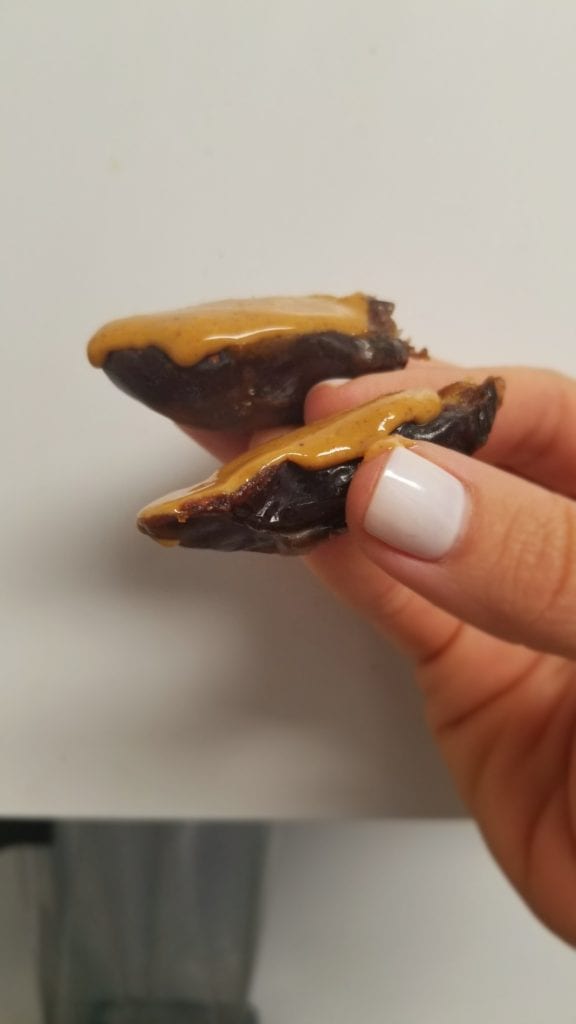 Medjool date with peanut butter - me holding the date in my hand