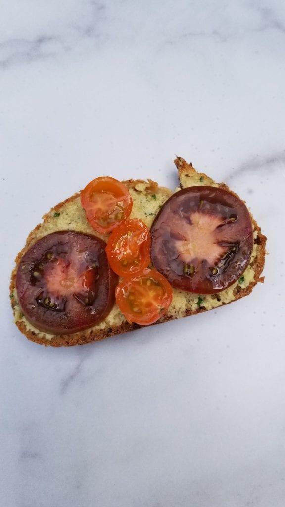 Zak the Baker sourdough break with alternative to cheese spread on top with tomato slices