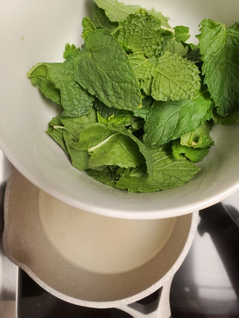 mint leaves adding to the simple syrup to flavor