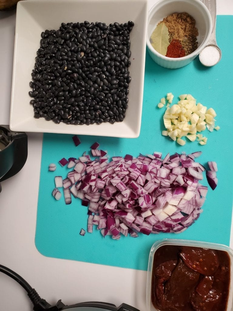 dried black beans, garlic, spices, and red onion