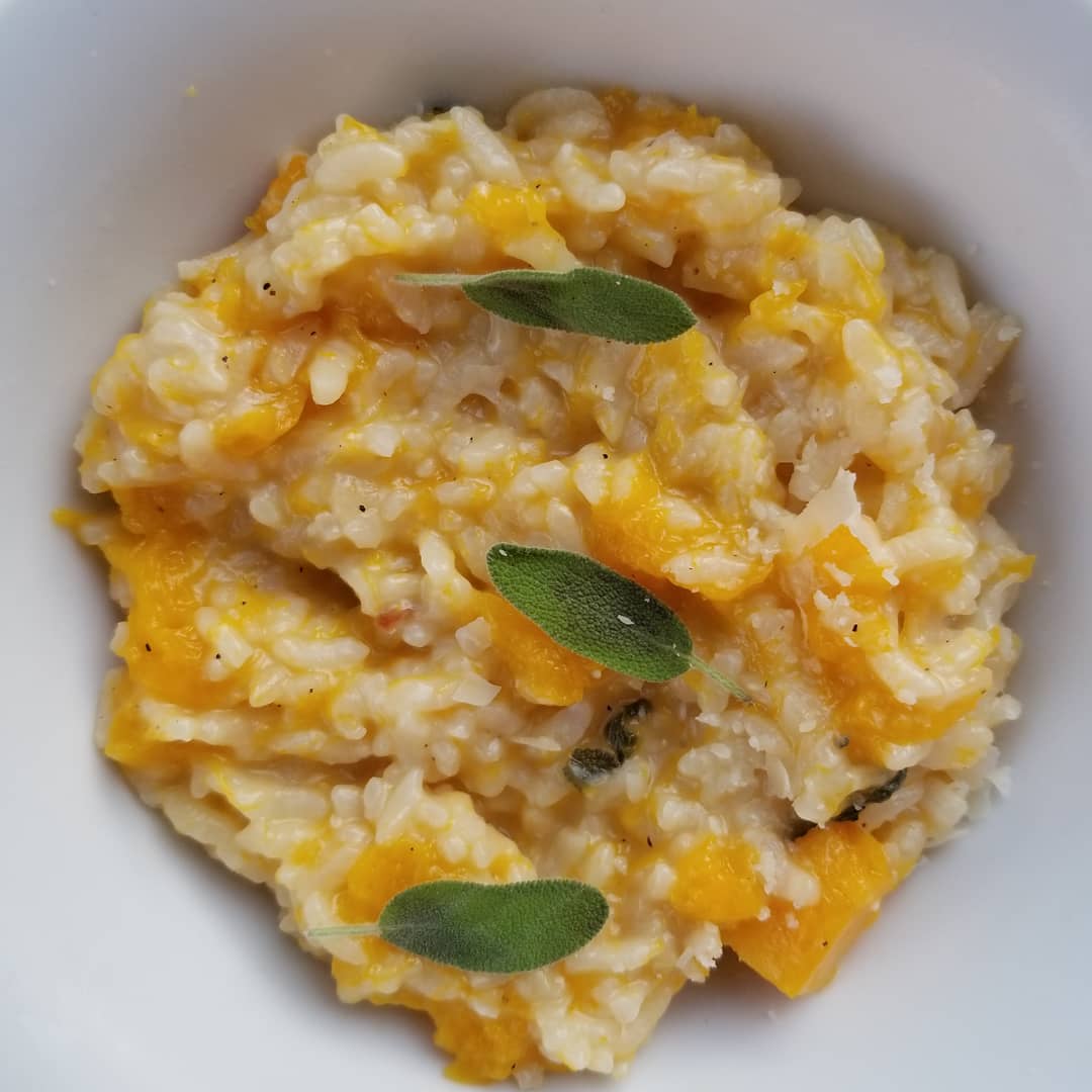 Close-up shot of butternut risotto with sage leaves on top