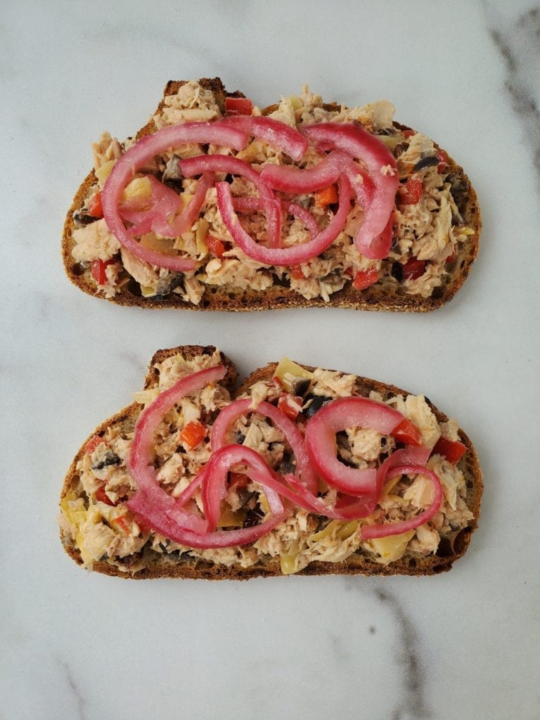 Open faced Tuna sandwich with pickled red onion on top