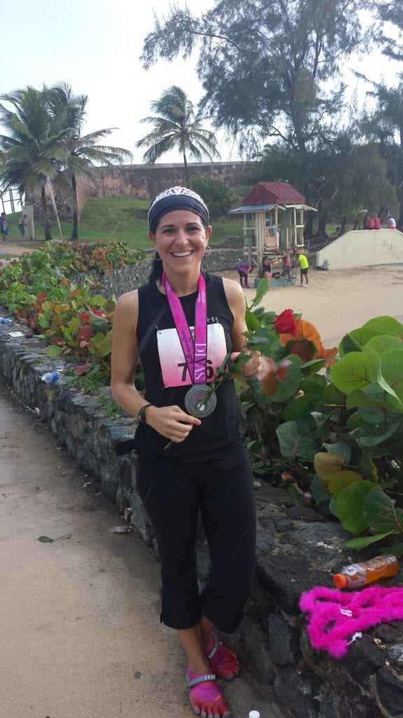 picture of me with my running medal and flowers after completing the San Juan Puerto Rico half marathon