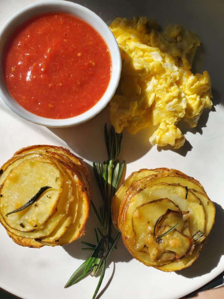 Rosemary Parmesan Potato Stacks on a plate with eggs and tomato jam