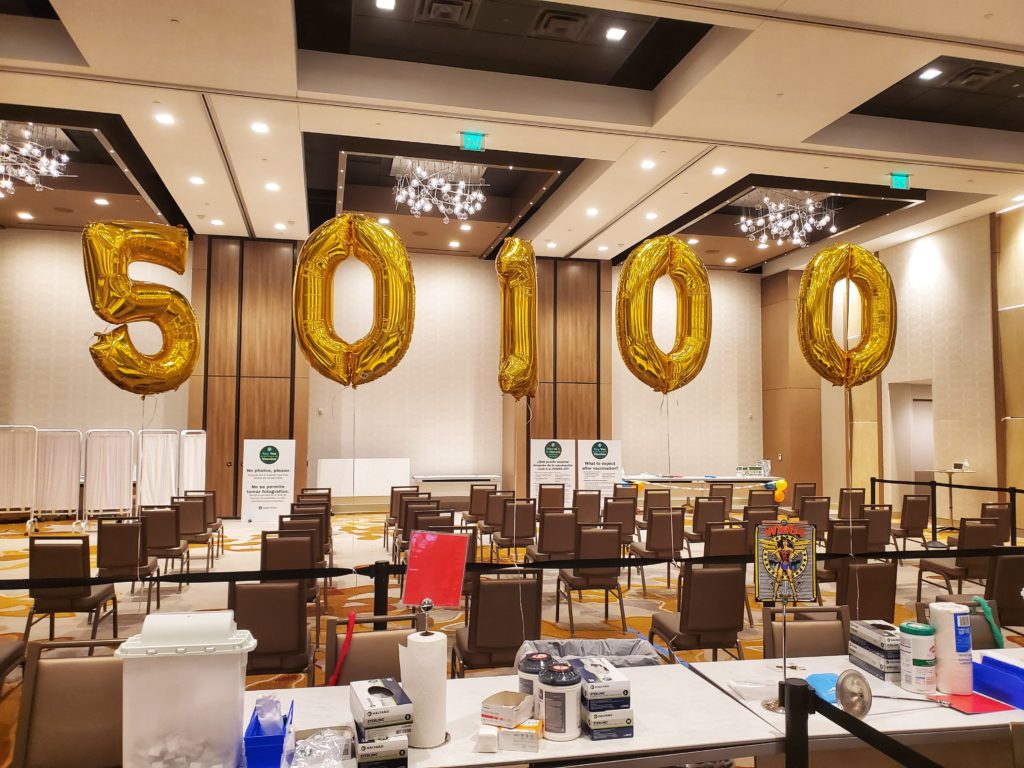 50,100 sign balloon representing the number of vaccines administered