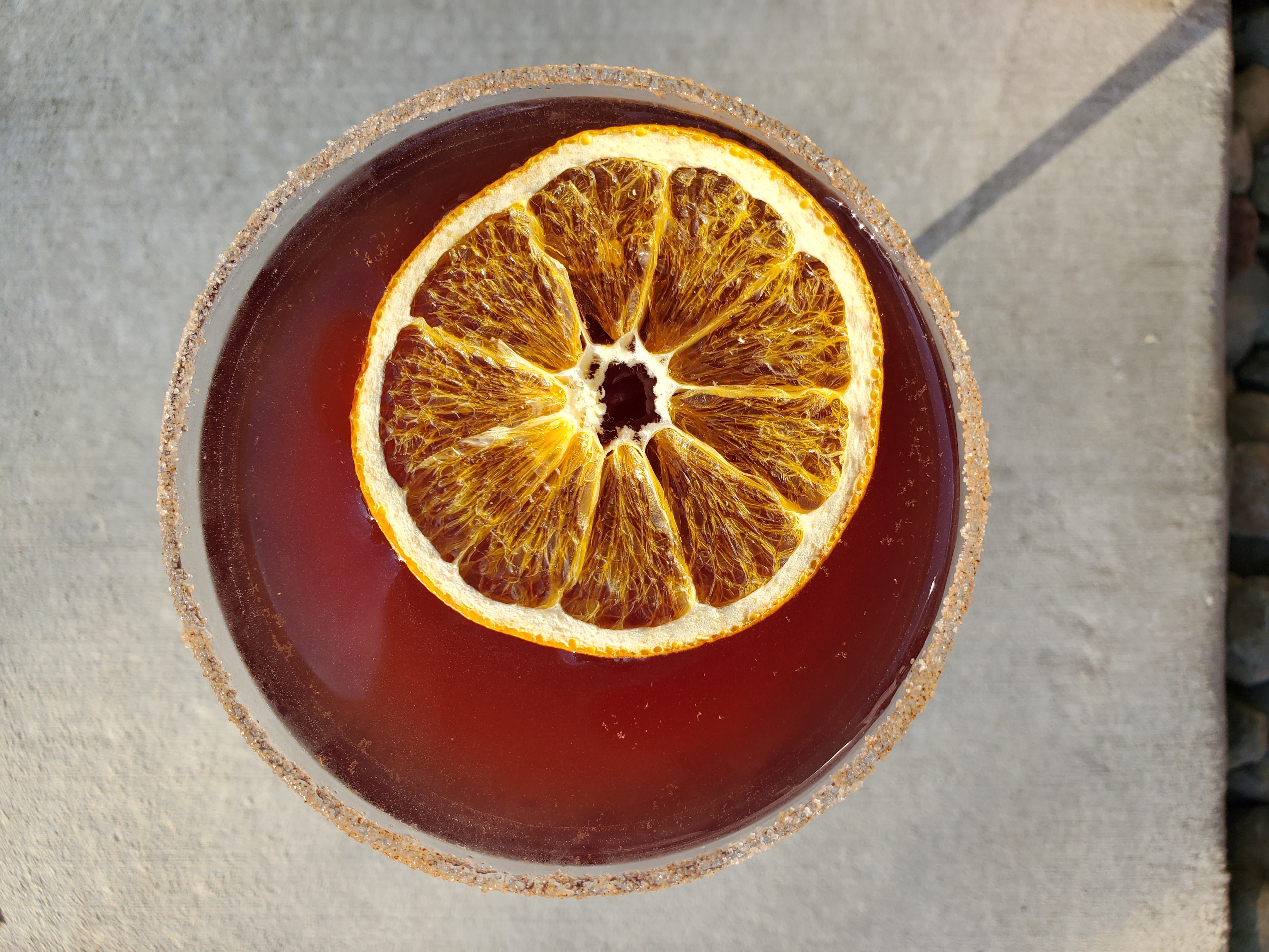 Drink with dried orange slice garnish on top