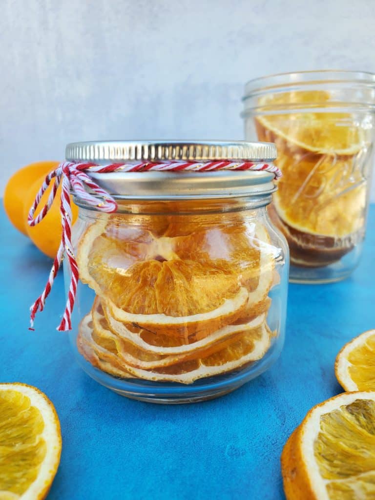 Dried Orange Slices in a Mason Jar displayed on a turquoise board