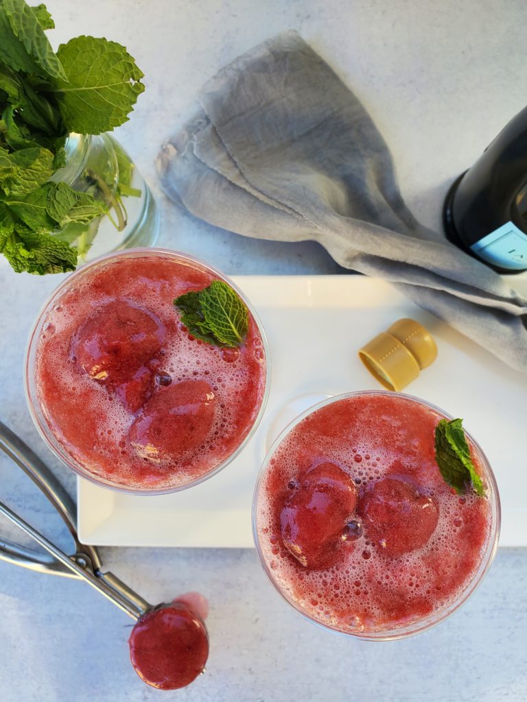 2 champagne glasses with sorbet and champagne poured on top