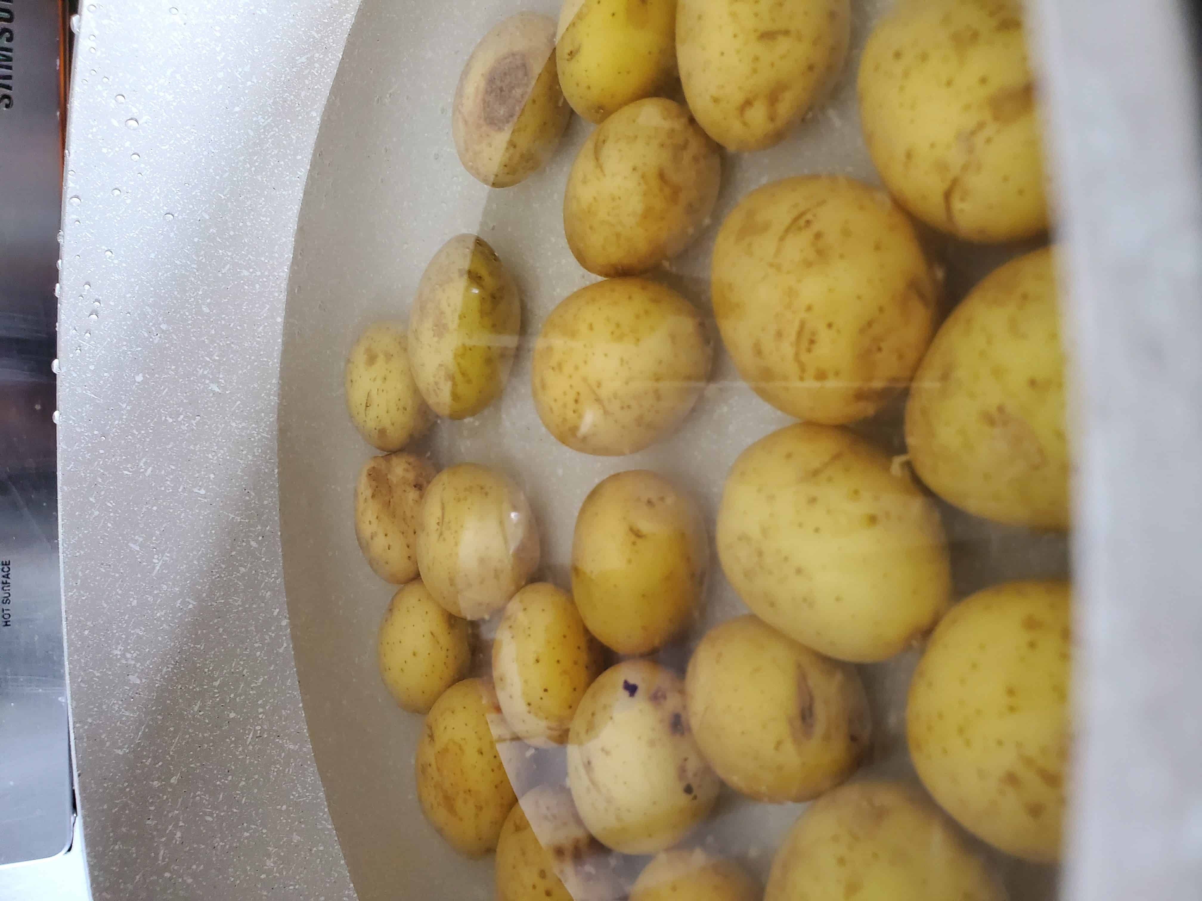 Potatoes covered by an inch of water to boil