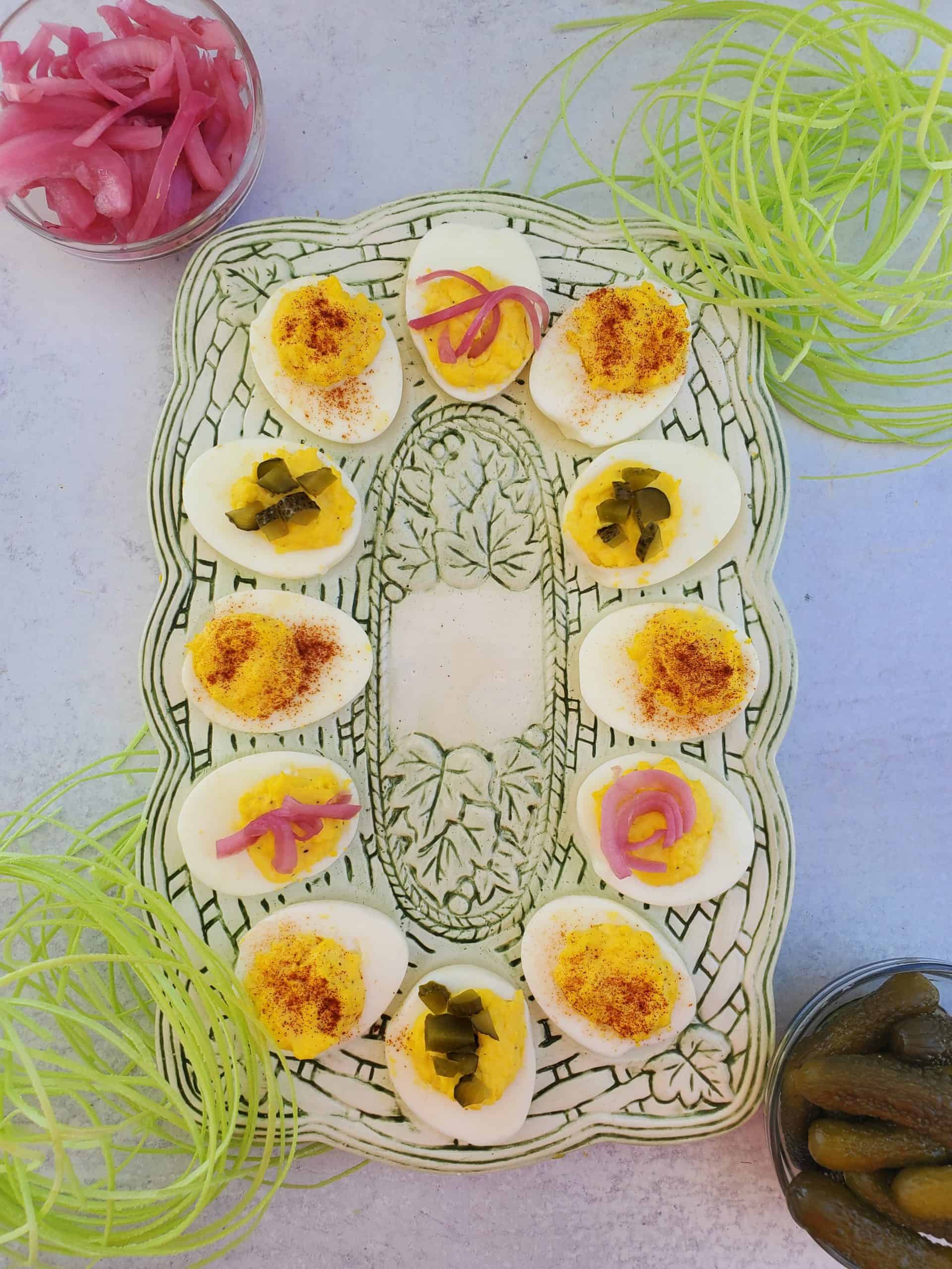 Classic Deviled Eggs on a platter with different toppings