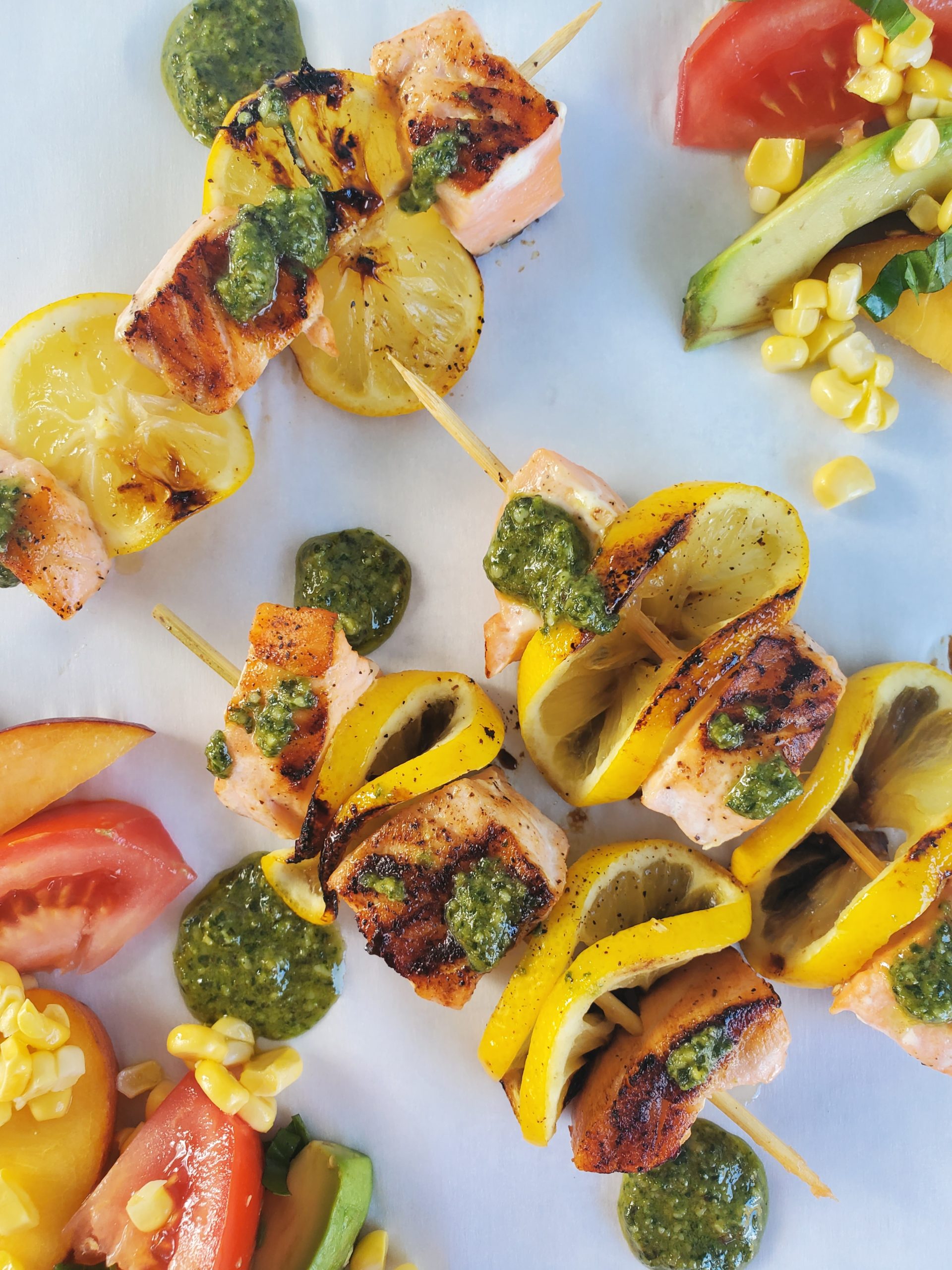 Salmon Skewers up close shot with corn tomato salad