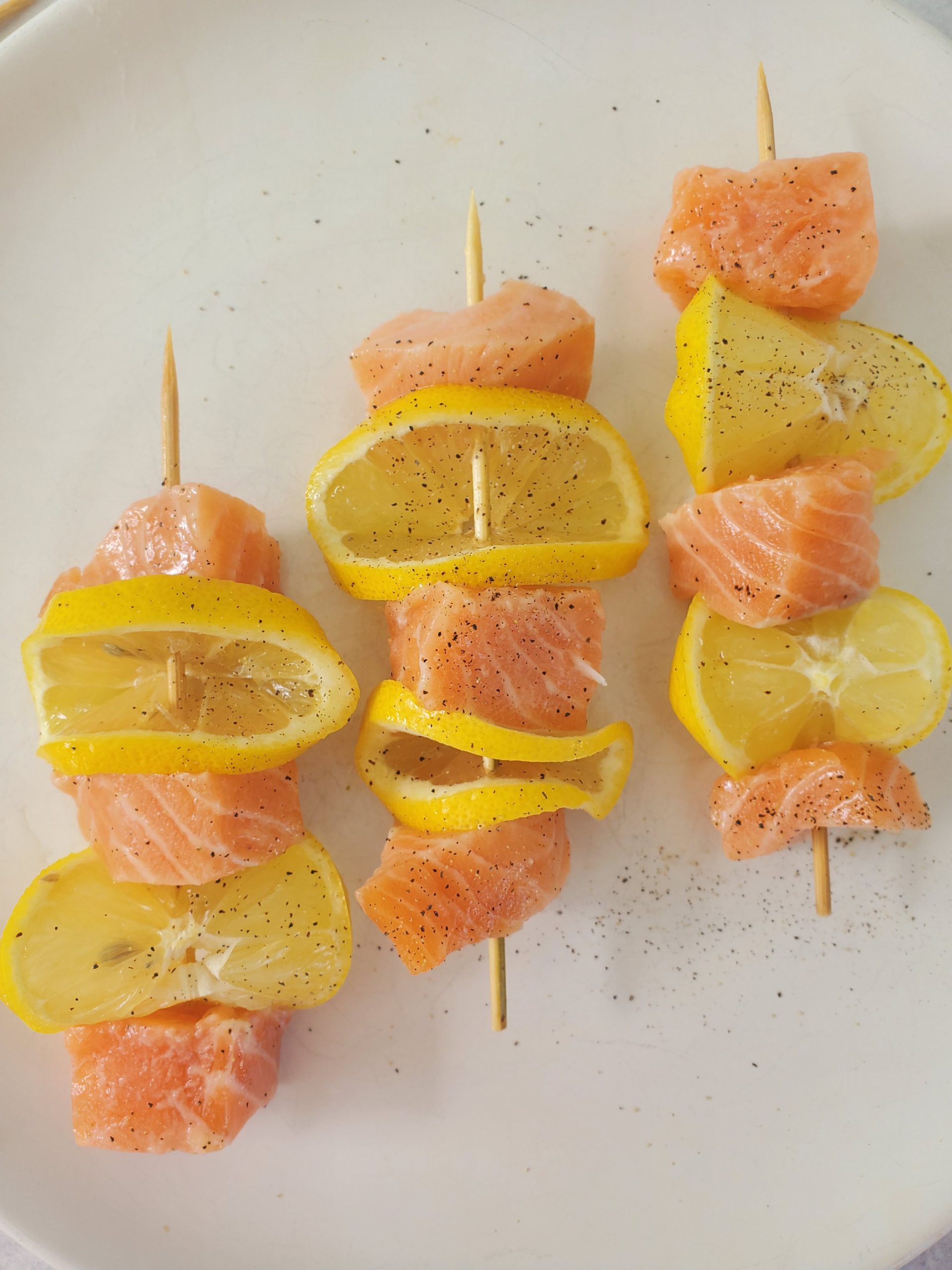 salmon on a skewer with lemon slices