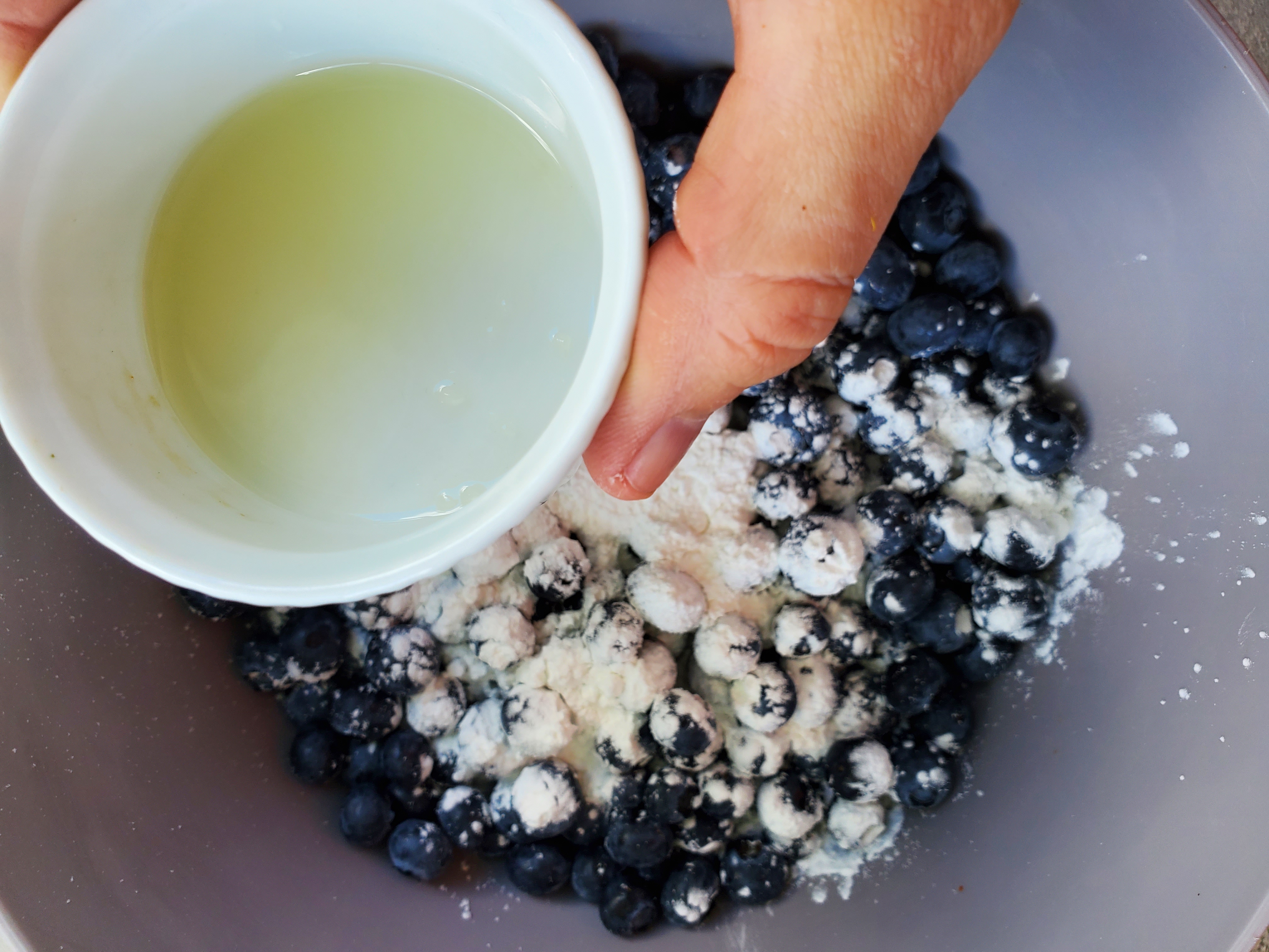 bowl of blueberries with cornstarch about to have lemon juice added