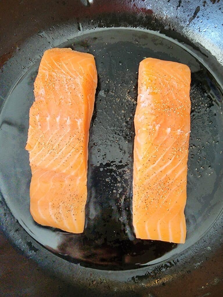 Salmon searing in a cast-iron pan