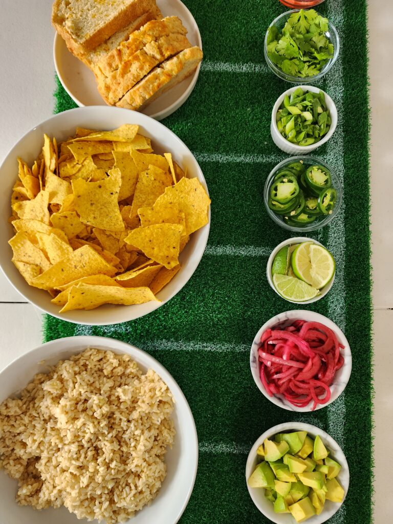 How To Set Up A Chili Bar - Toppings - Brown Rice, Tortilla Chips, Beer Bread, Avocado, Pickled Red Onion, Limes, Jalapenos, Scallions