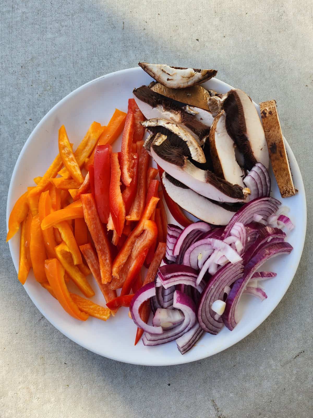 Plate of Portobello Mushroom, Red and Orange Bell Peppers, Red Onion - for Portobello Fajitas