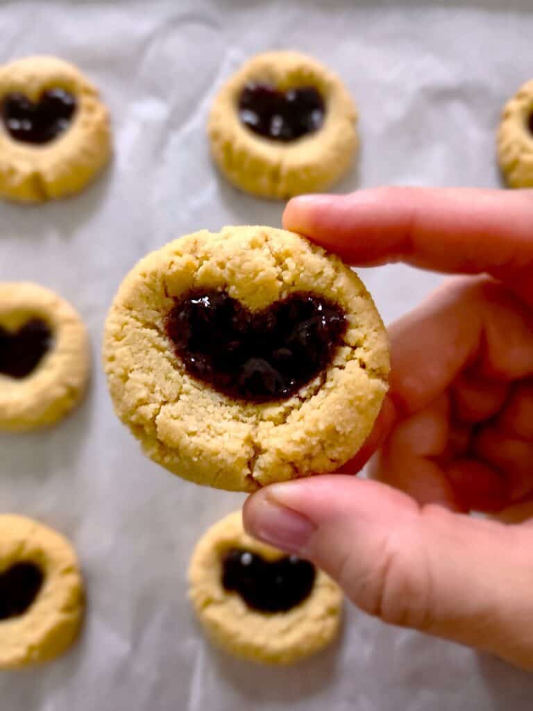 Close-up picture of a single thumbprint cookie in the shape of a heart
