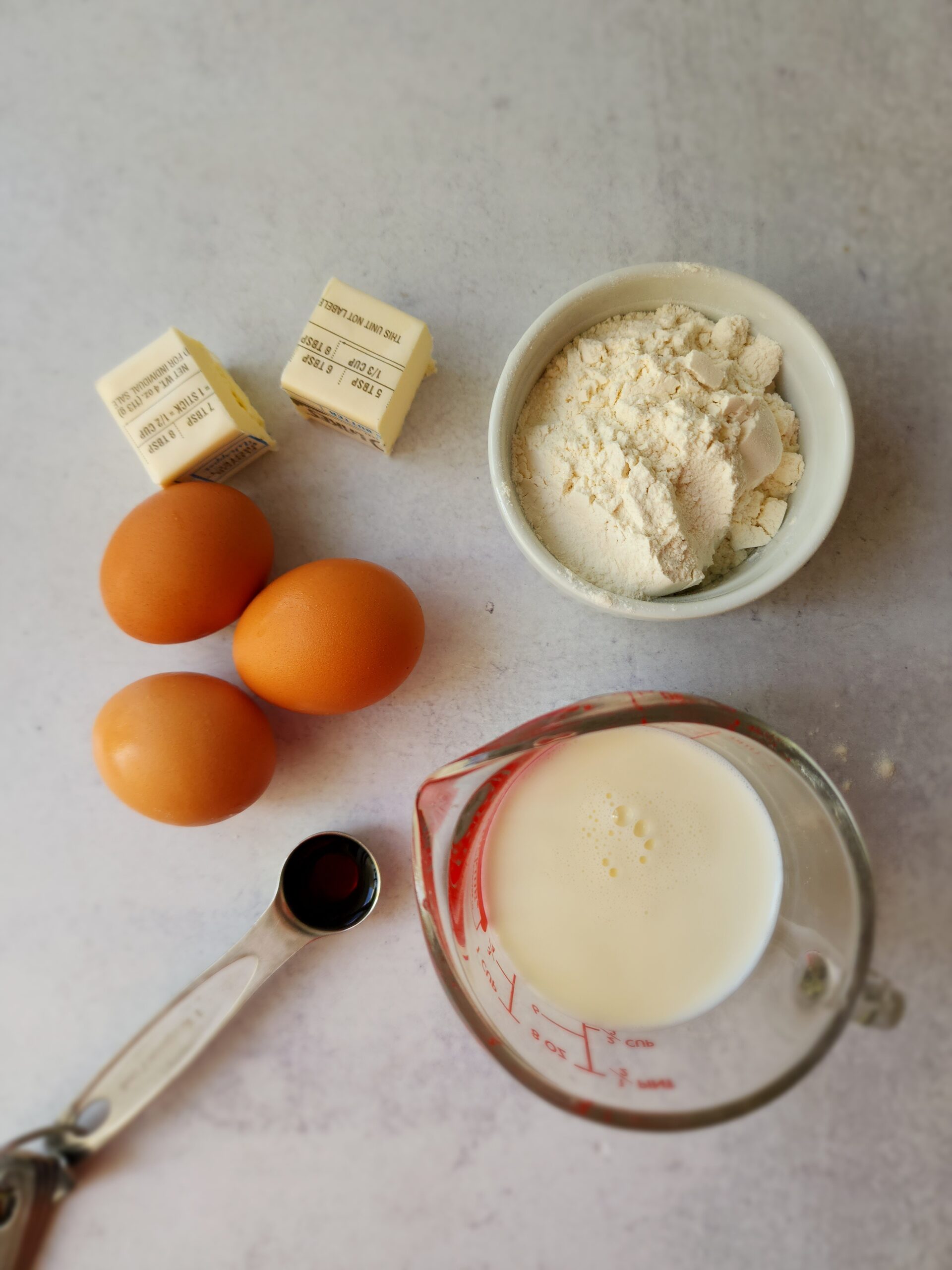 Ingredients for a Blender Dutch Baby - eggs, vanilla, flour, butter, and milk