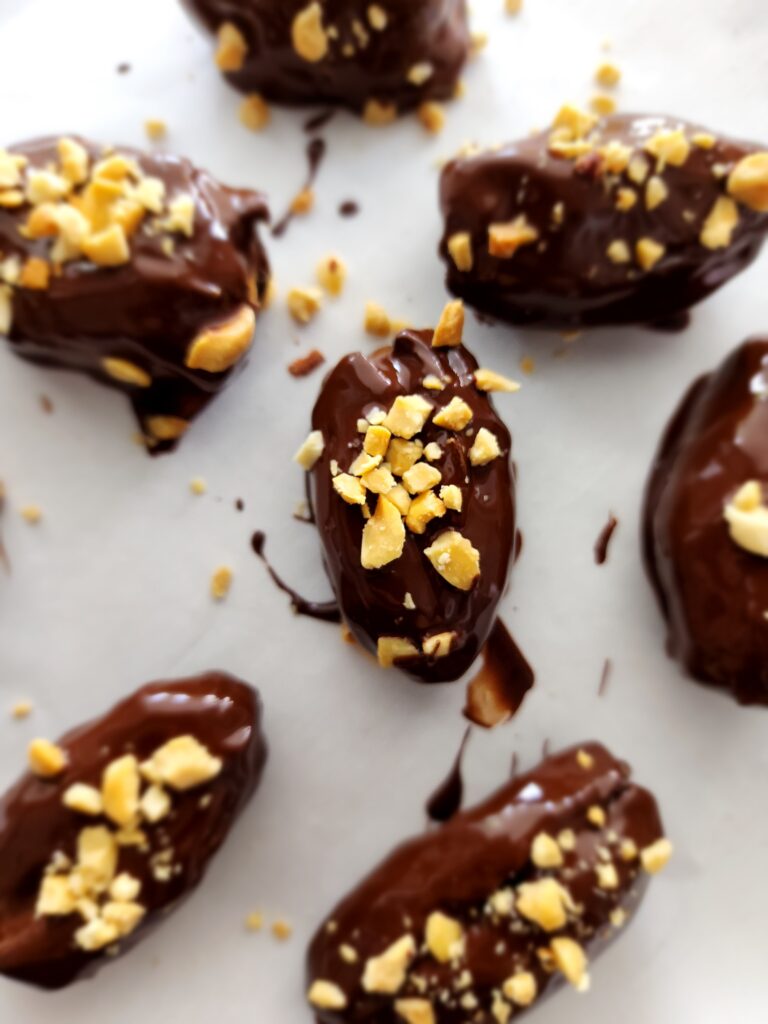 Chocolate Covered Dates with Peanut Butter sprinkled with chopped peanuts