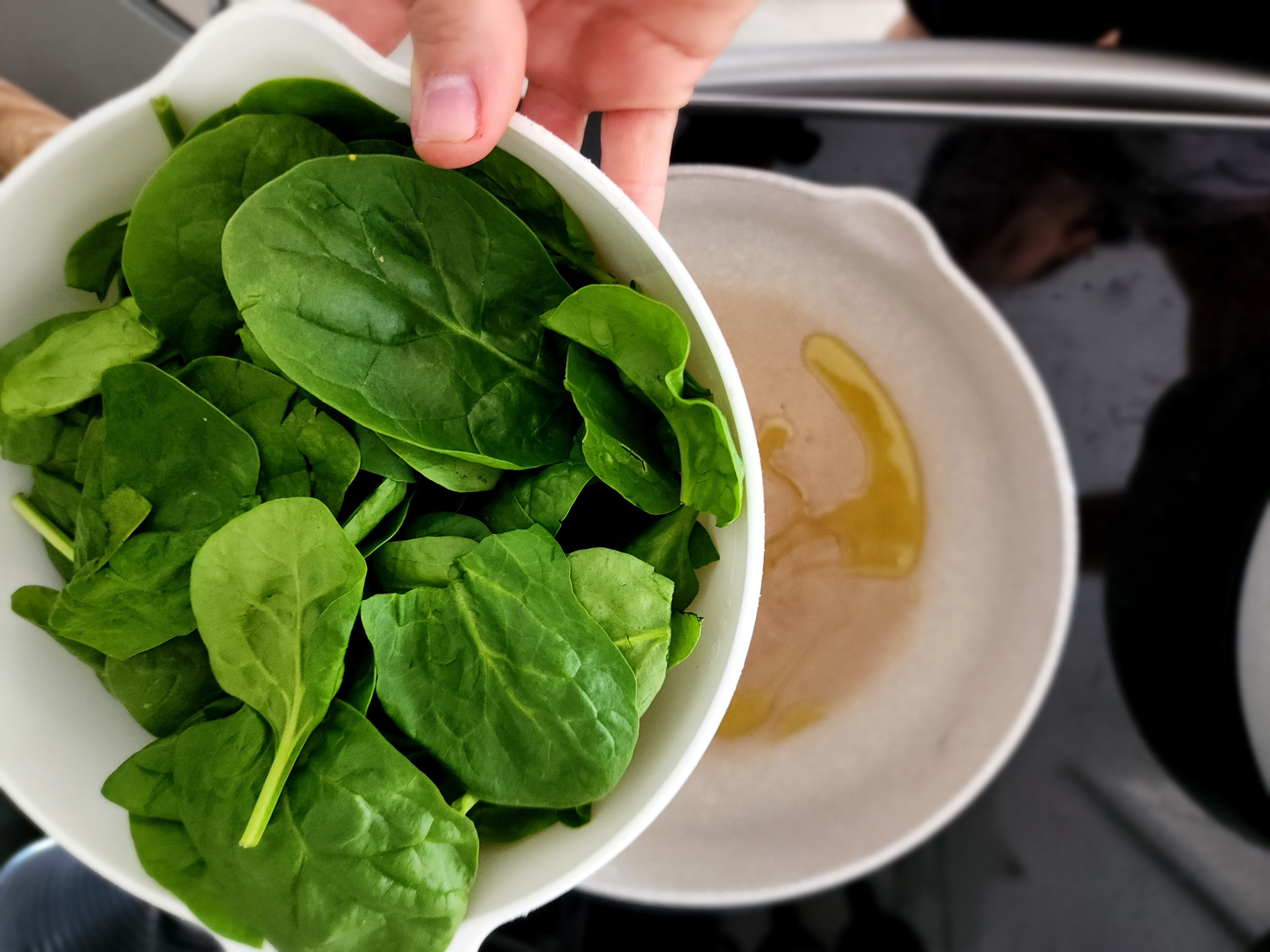 spinach about to be cooked in olive oil