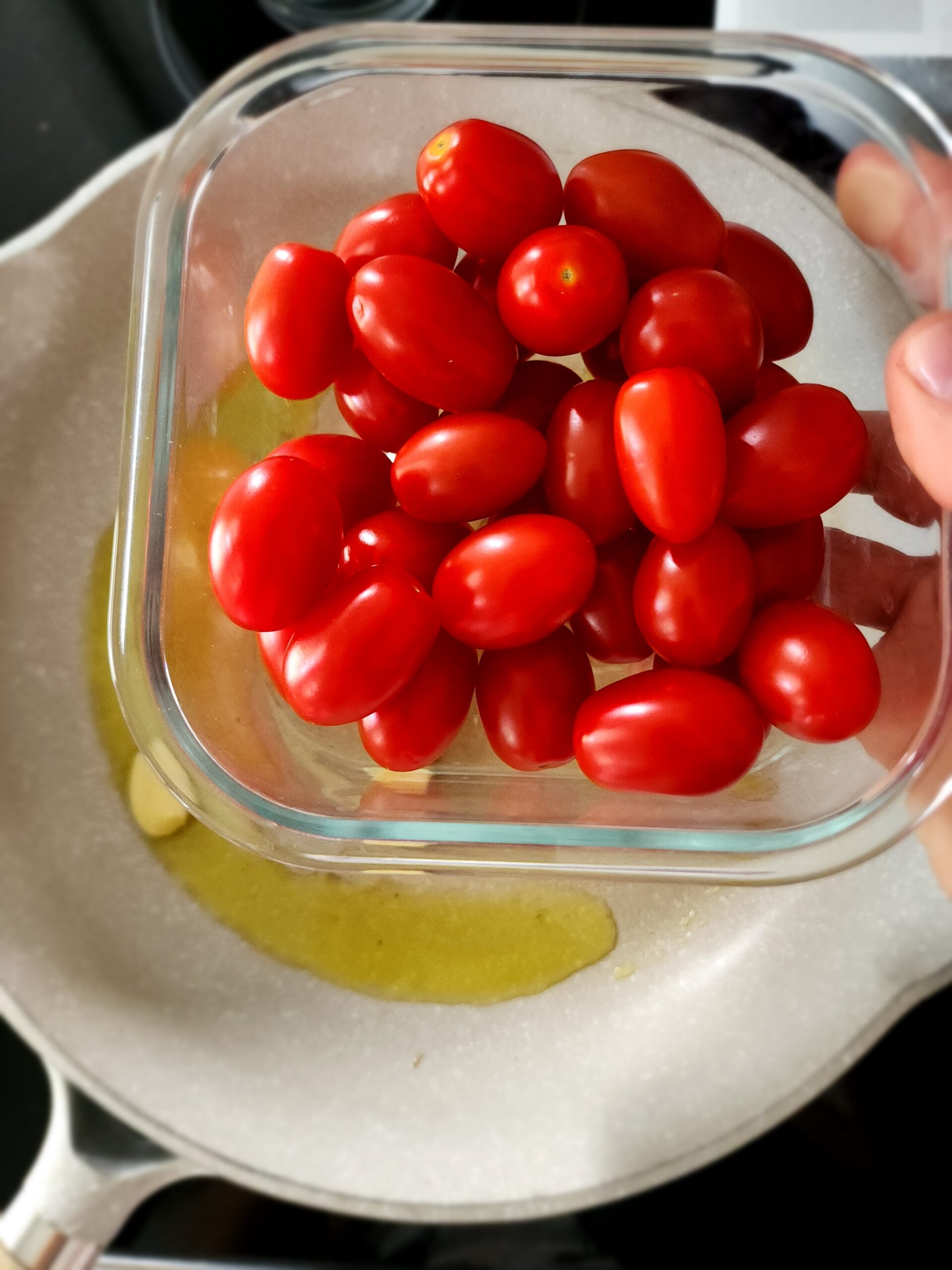 Grape tomatoes about to be cooked in olive oil