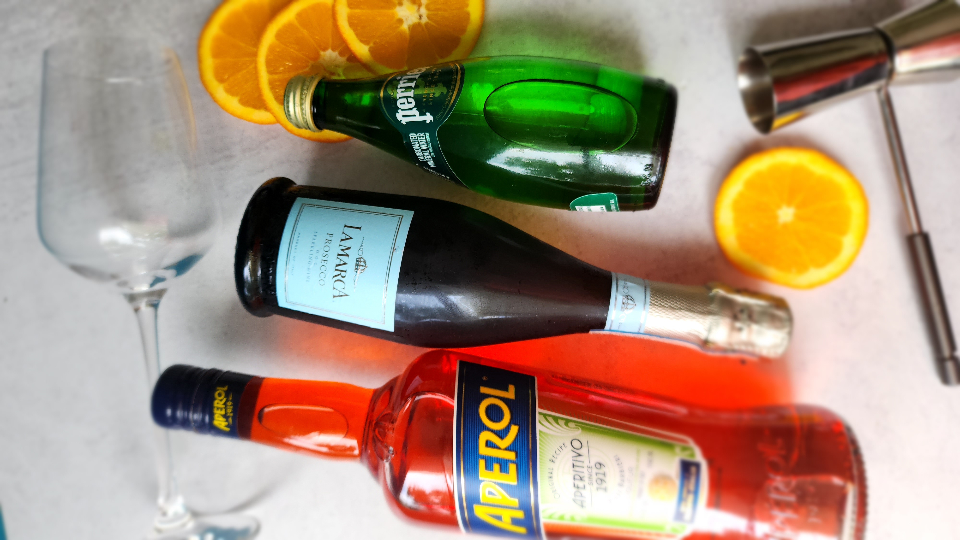 ingredients for an Aperol spritz:  prosecco, club soda, Aperol