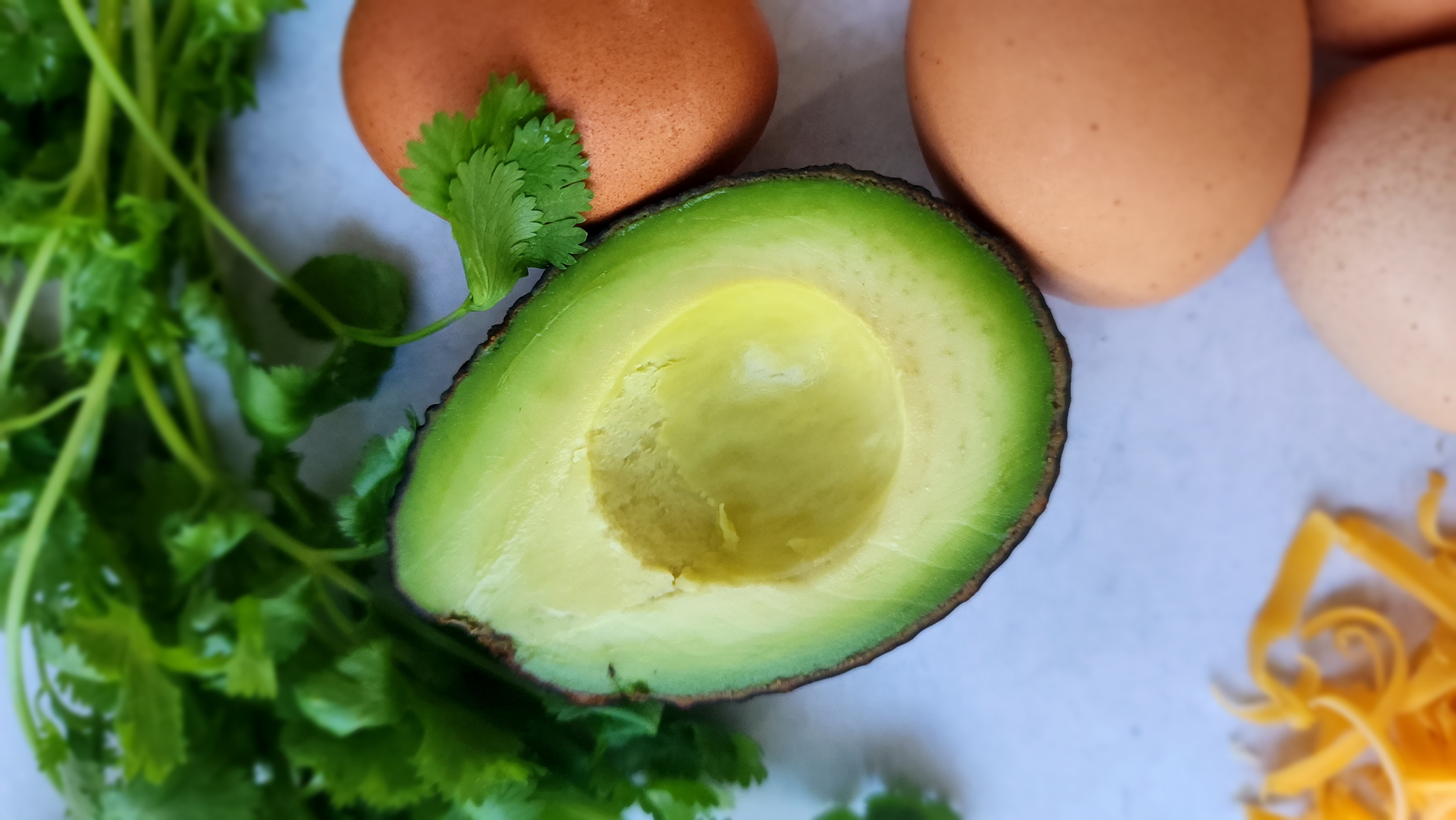 Close-up shot of a cut-open avocado for breakfast tacos