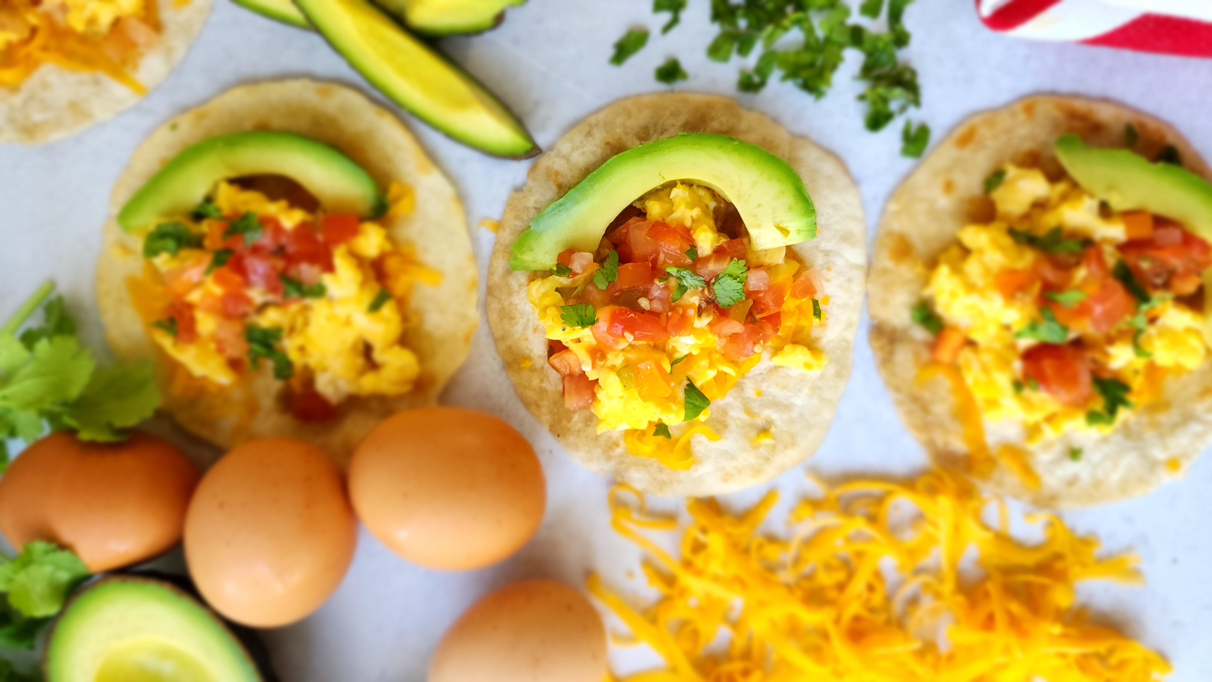 Breakfast Tacos with eggs, cheese, pico de gallo avocado, and cilantro