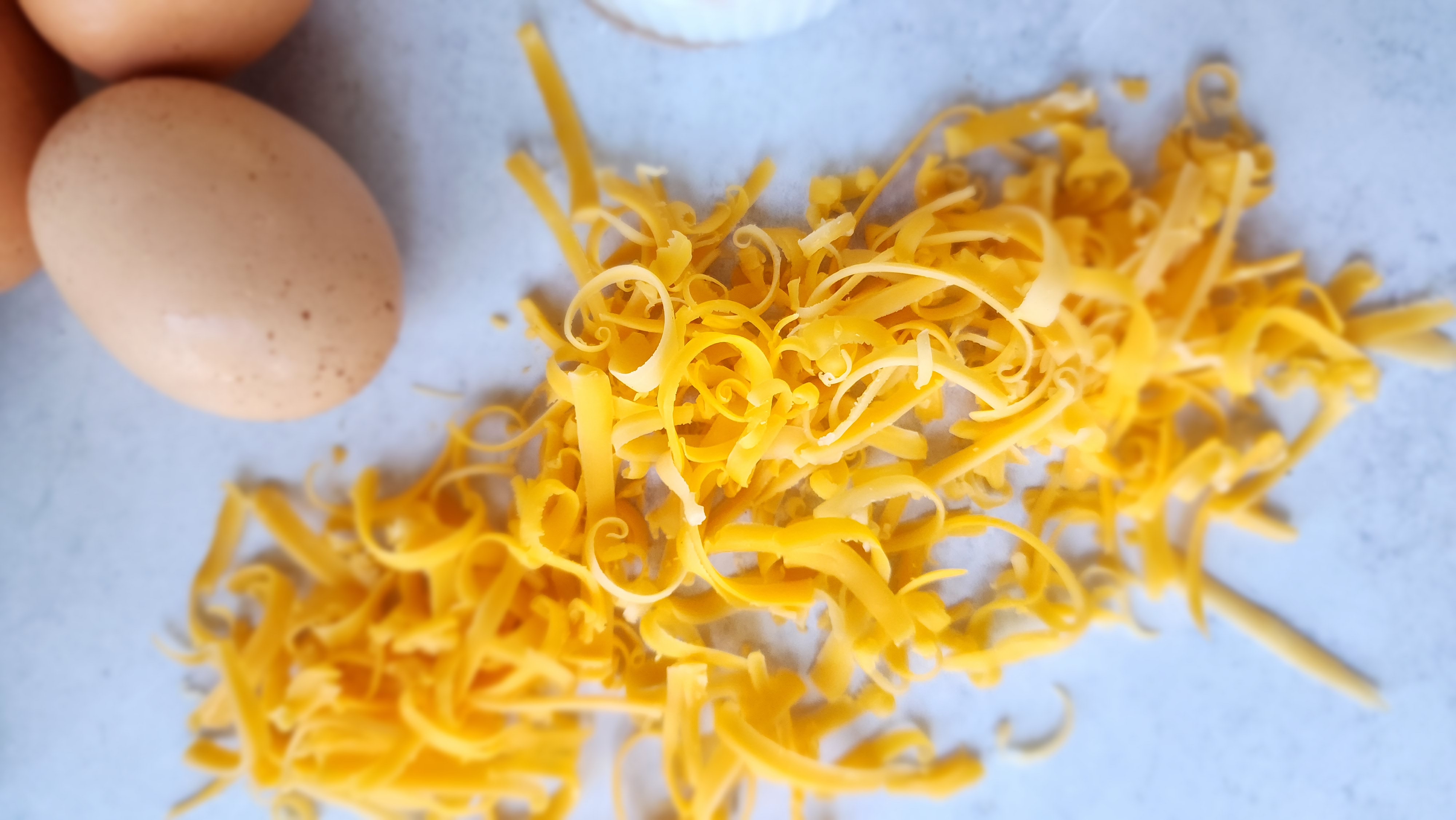 Close-up shot of shredded cheese for breakfast tacos