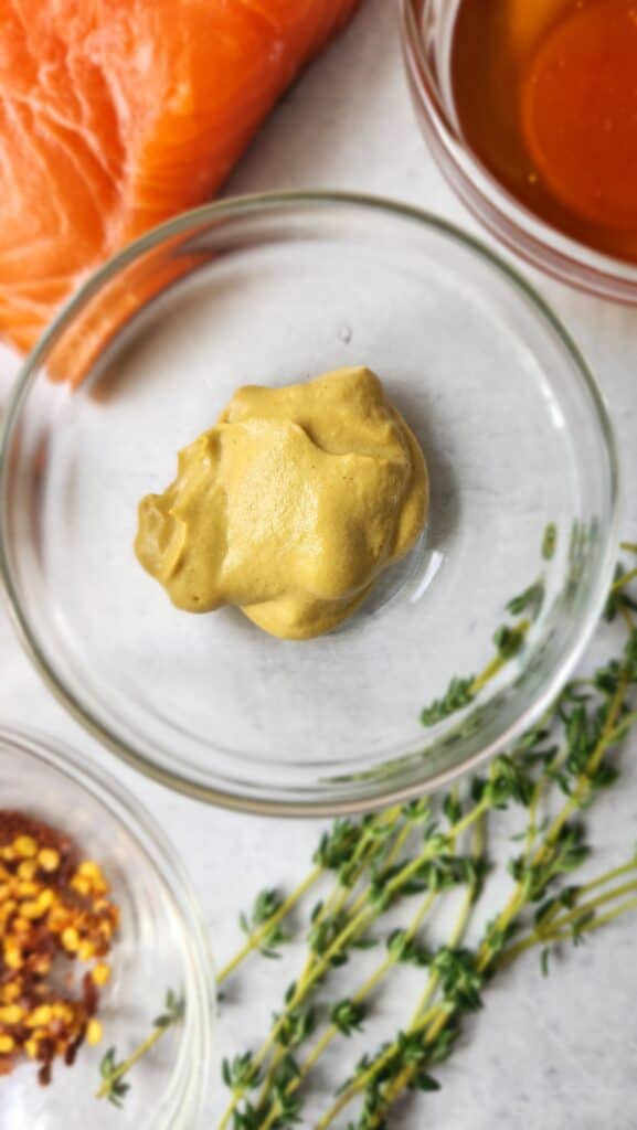 Close-up picture of dijon mustard in a clear glass bowl