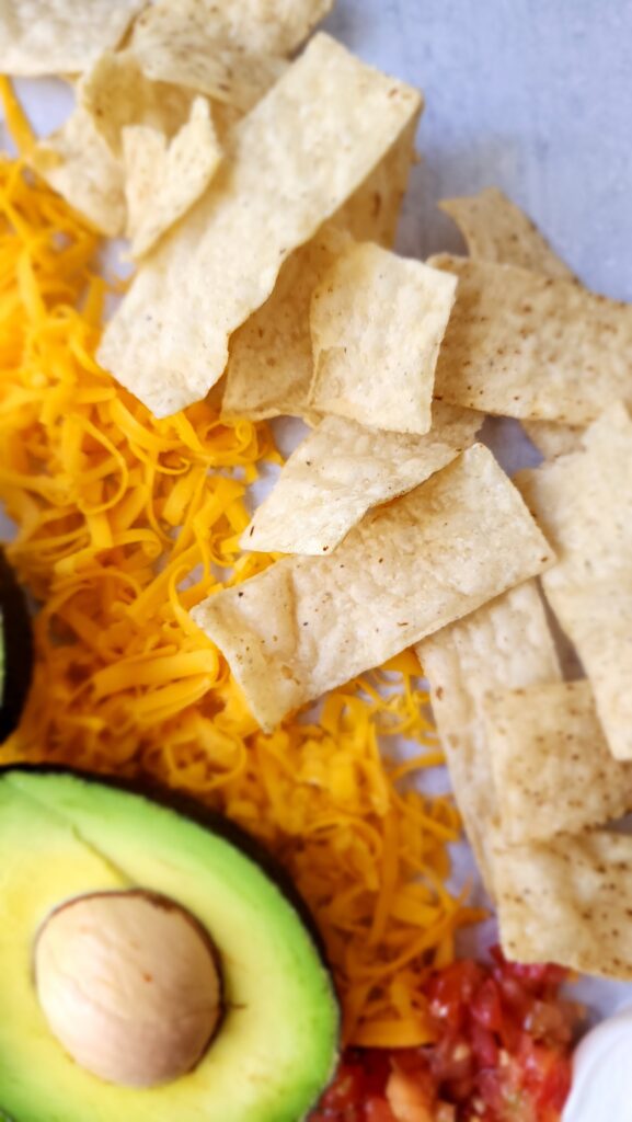 toppings for taco salad - but with a close-up of tortilla chips