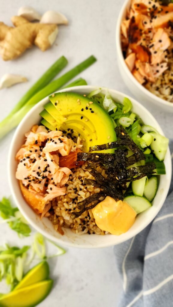 Sushi bowl with salmon, avocado, cucumber, and seaweed