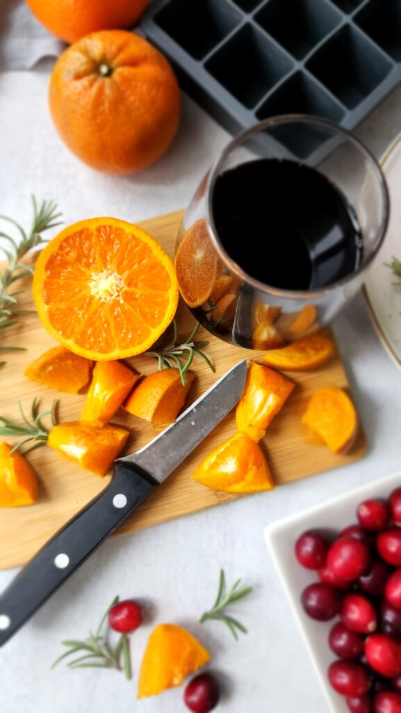 DIY Flavored Ice Cubes - Cutting board of oranges cut into orange triangles