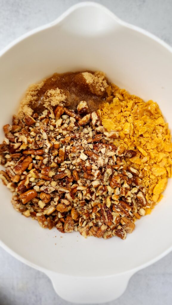 sweet potato casserole toppings added to a mixing bowl