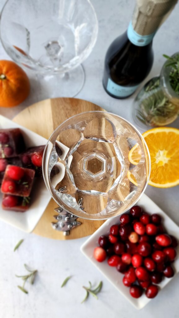 Top Shot Champagne Glass with cranberries, oranges, and champagne for Pomegranate Mimosas
