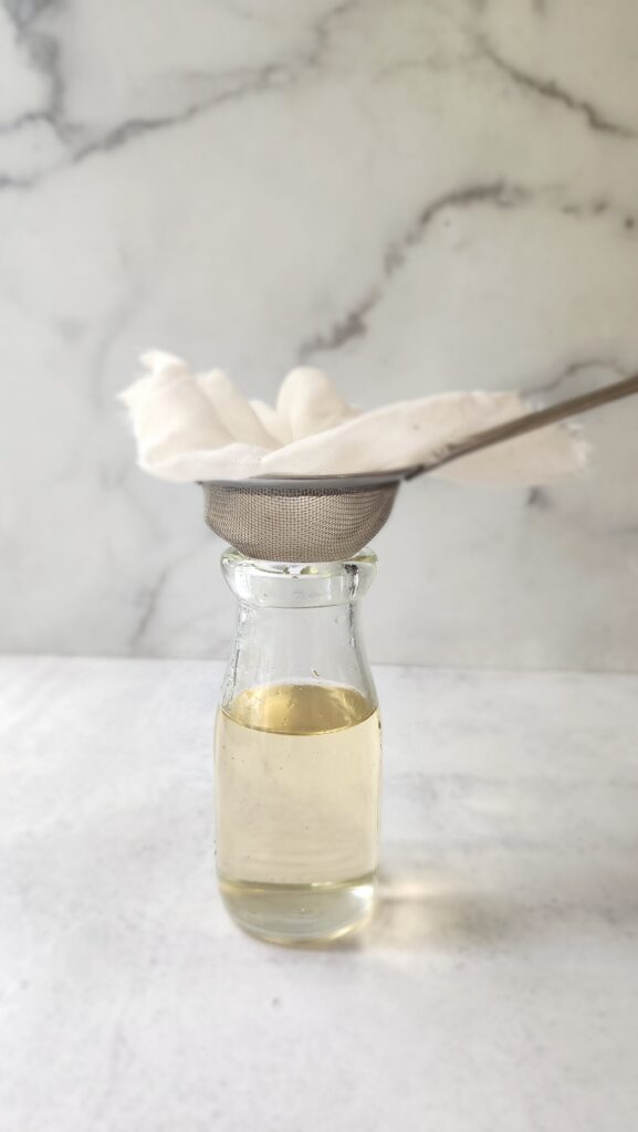 Filtering with a cheesecloth the lavender syrup to remove any debris