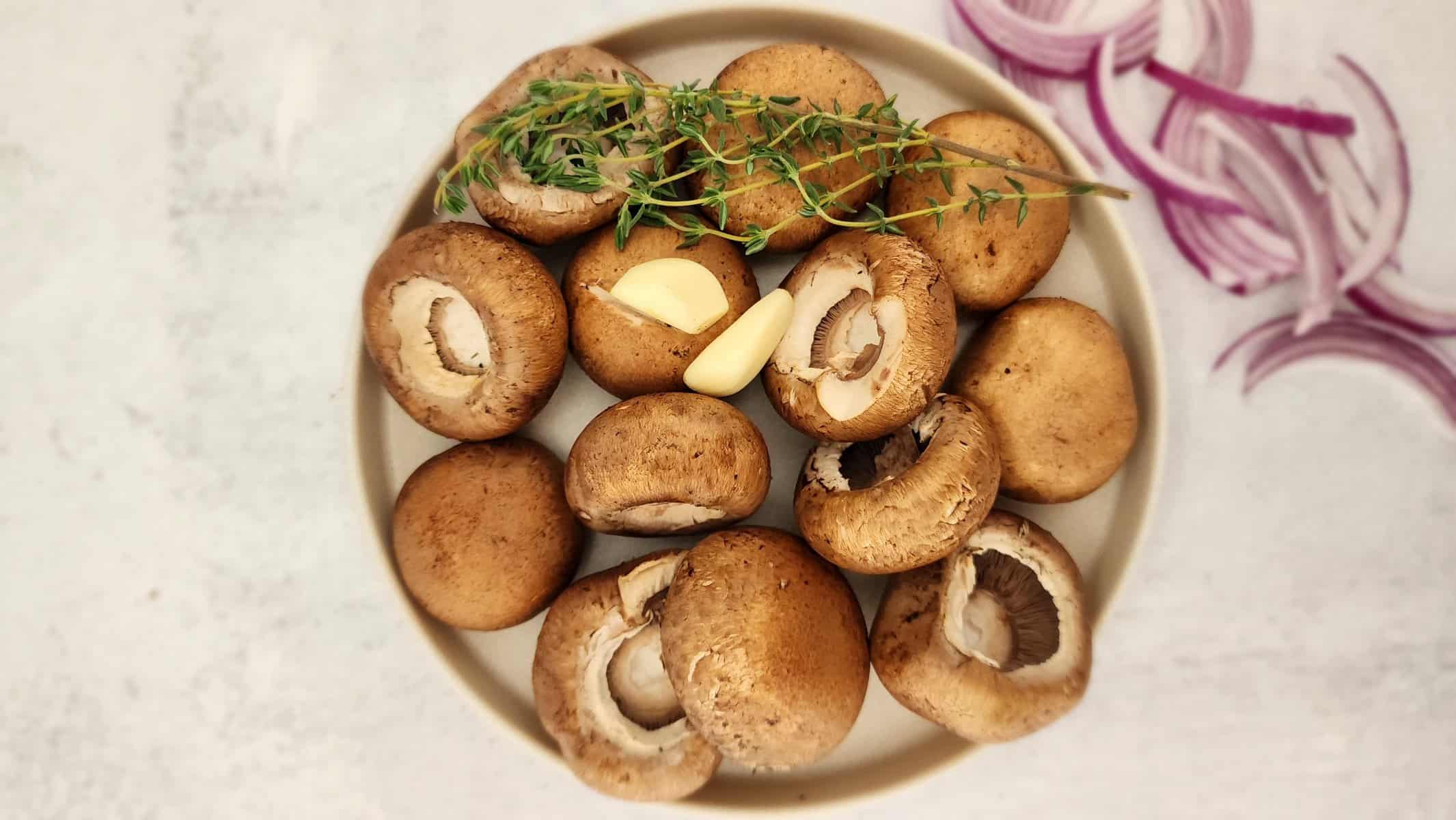 ingredients for marinated mushrooms - mushrooms, thyme, red onion