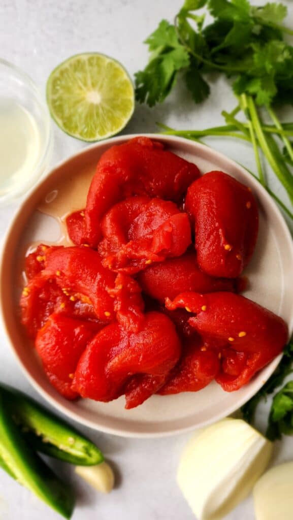 ingredients for easy homemade salsa - canned tomatoes, cilantro, jalapeno, lime, salt