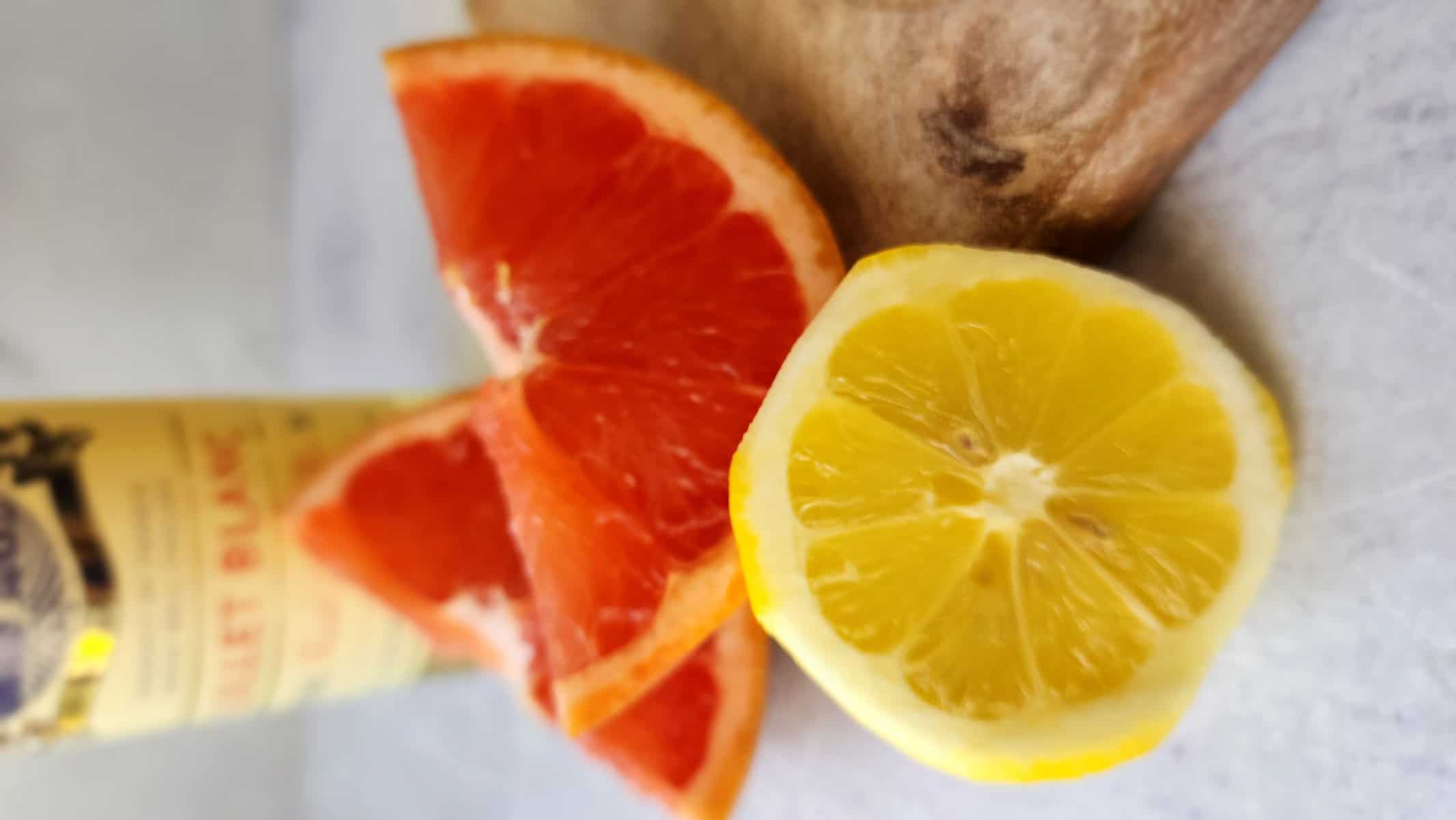 close-up shot of a wedge of lemon and wedge of grapefruit