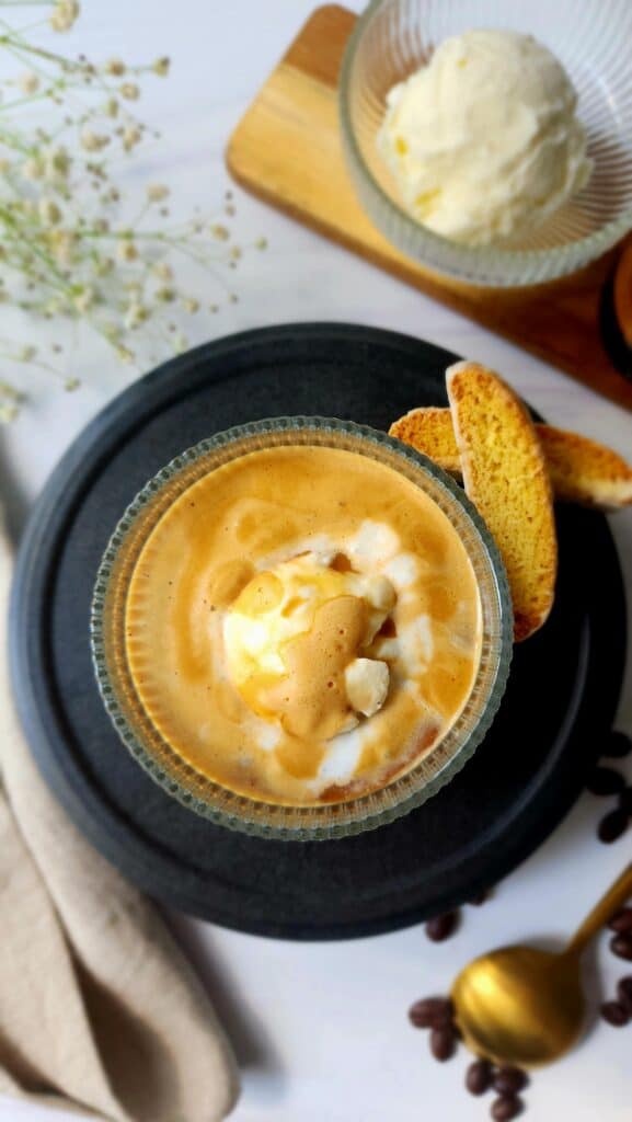 top shot of a scoop of vanilla ice cream with espresso poured on top