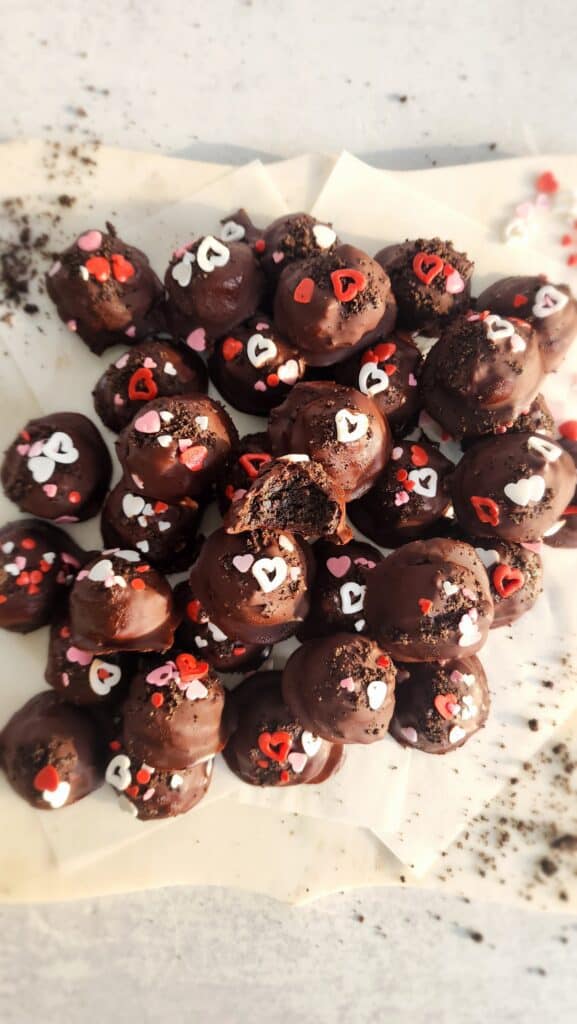 one bite out of an Oreo truffle sitting on top of other truffles