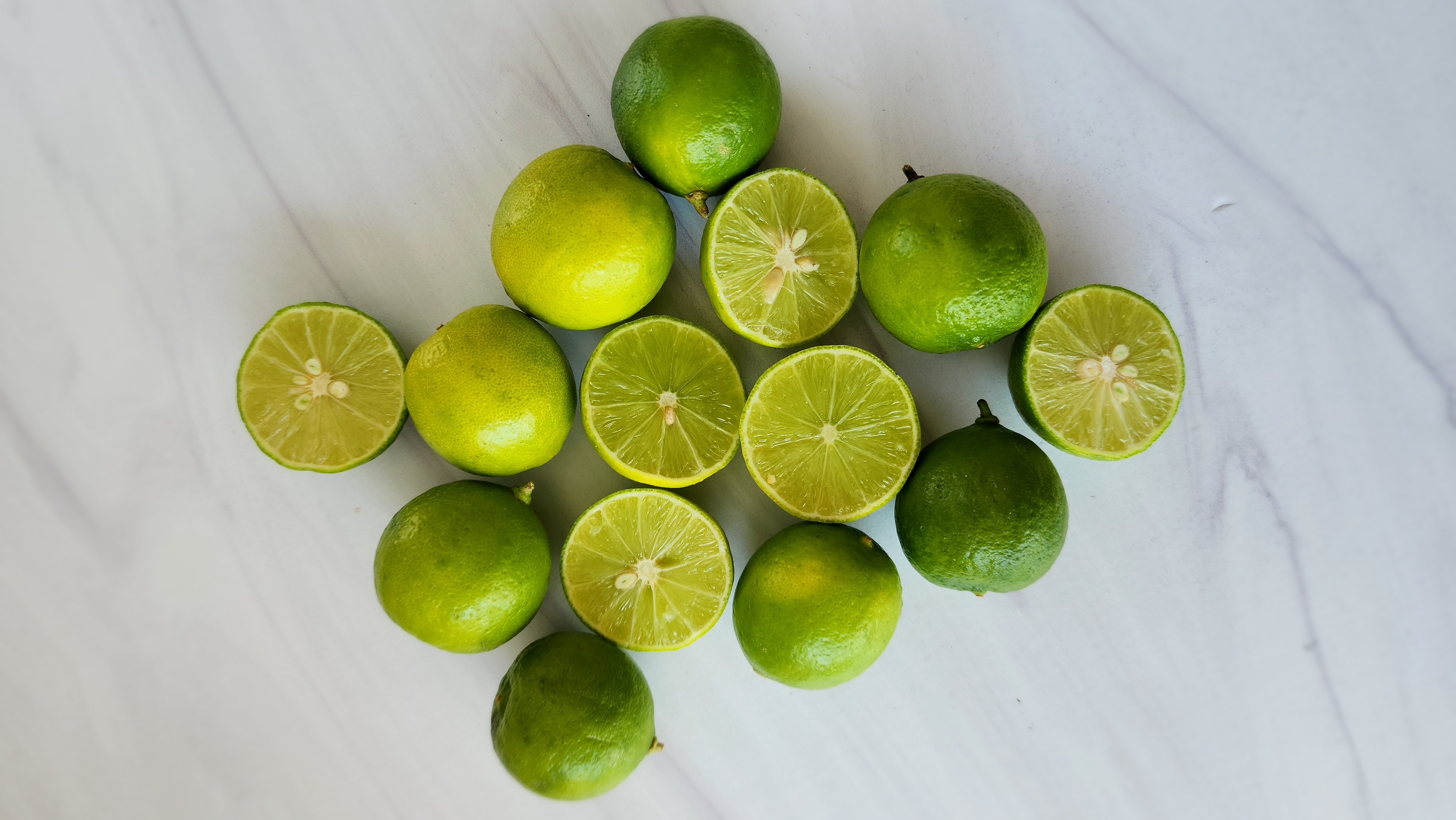 key limes, some whole and a few cut in half