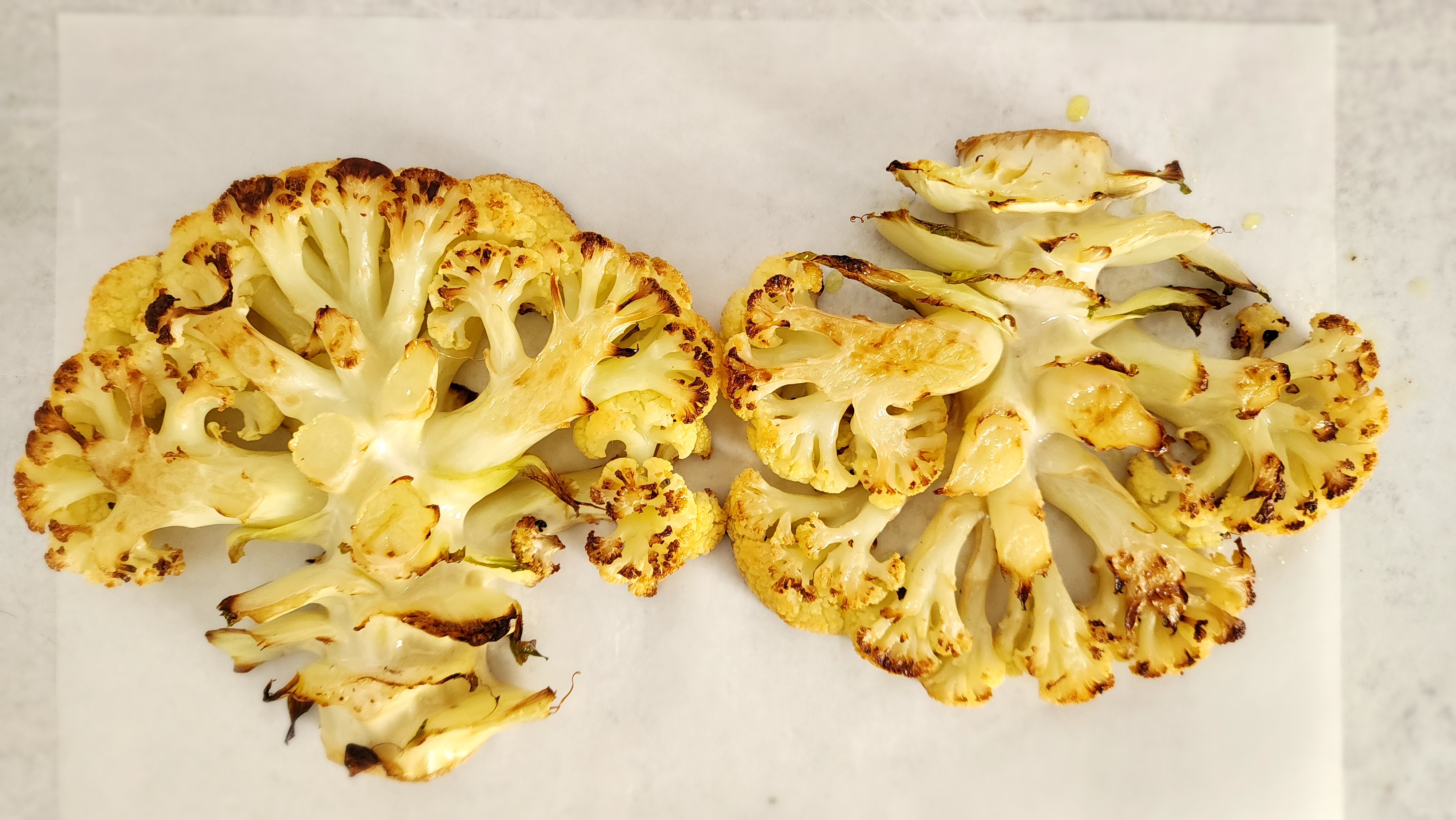 two roasted cauliflower 'steaks'