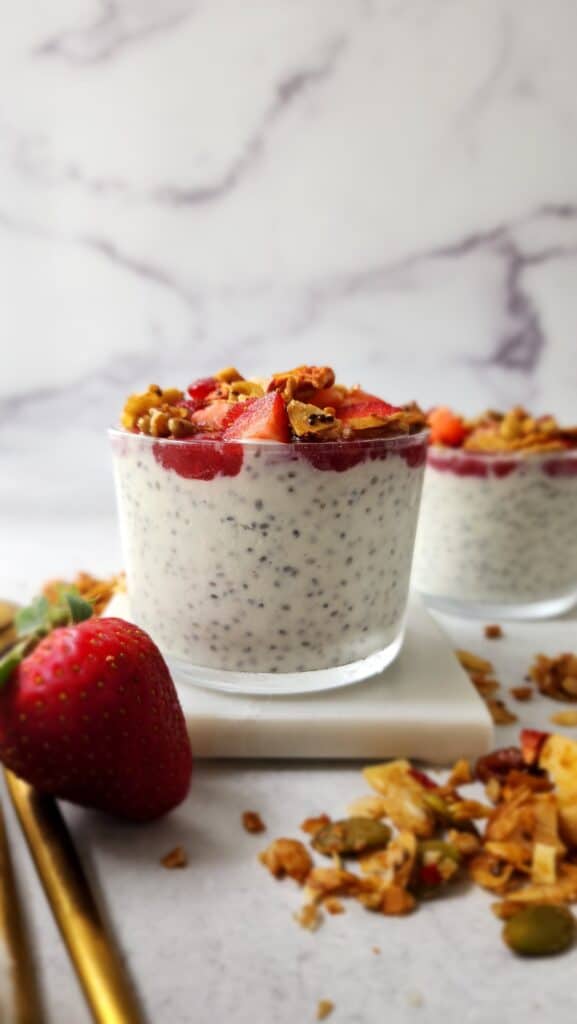 Front shot of Greek Yogurt Chia Seed Pudding with easy strawberry sauce and granola on top