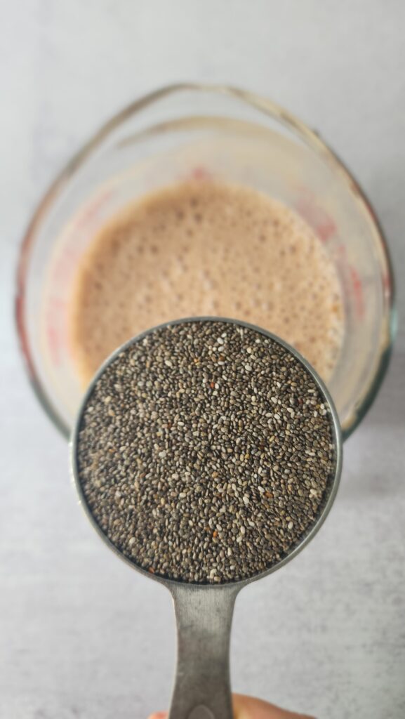 adding chia seeds to the chocolate mixture for chocolate chia seed pudding
