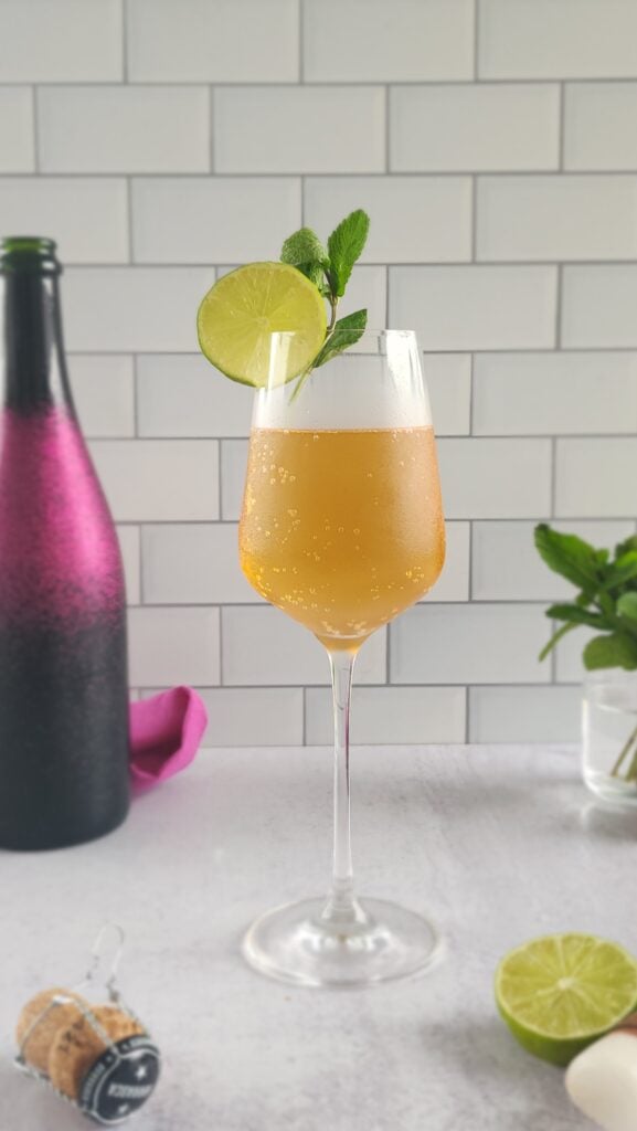 glass of Rosé Hugo Spritz with a lime and mint garnish