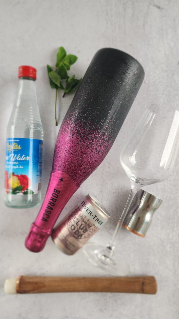 all the ingredients to make a Rose Hugo Spritz - Rose Prosecco, club soda, rose water, mint