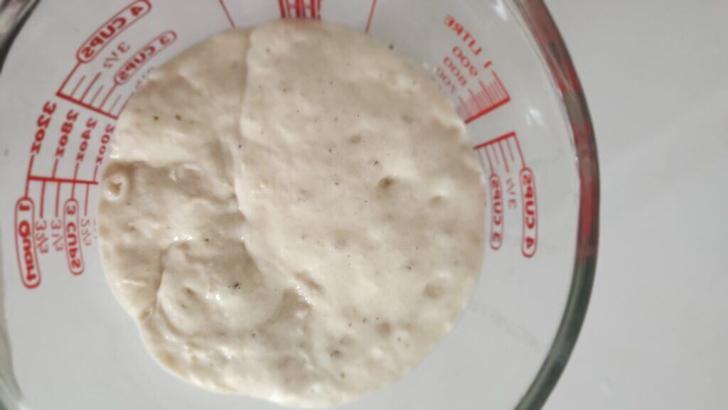 top shot of a measuring glass with my sourdough starter