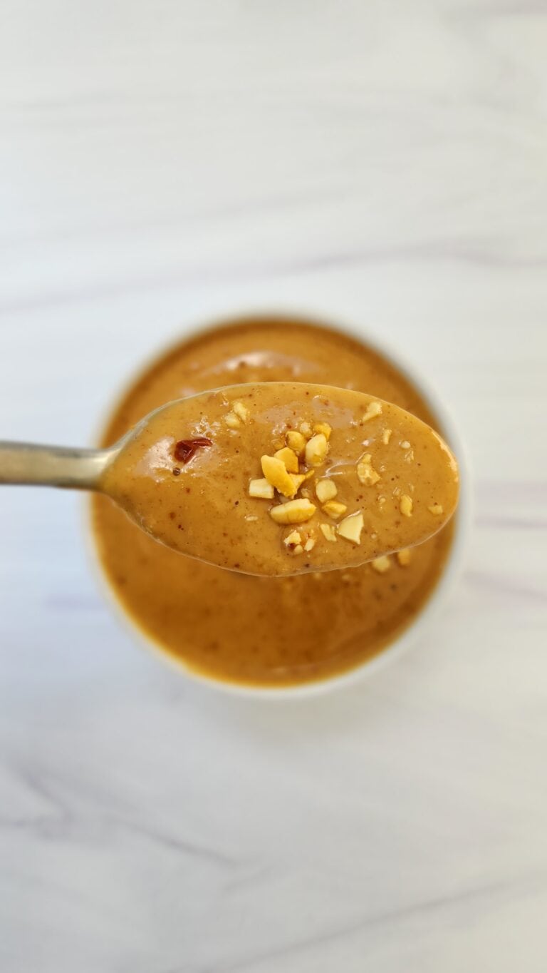 spoon full of easy peanut sauce in a ramekin